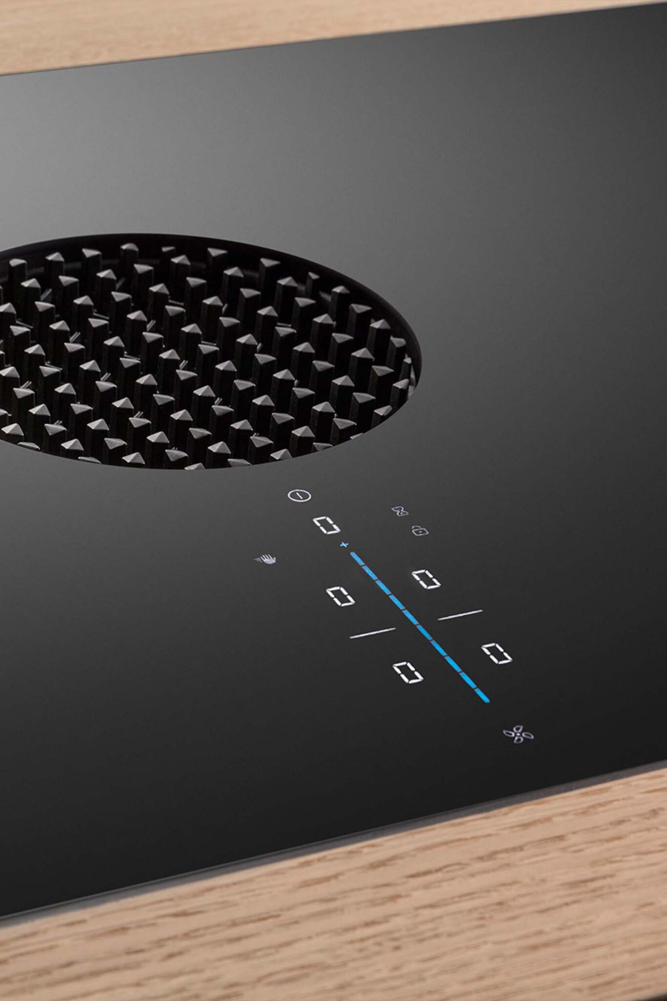 Close-up of BORA X Pure induction cooktop with illuminated sControl Plus slider and seamless black glass surface.