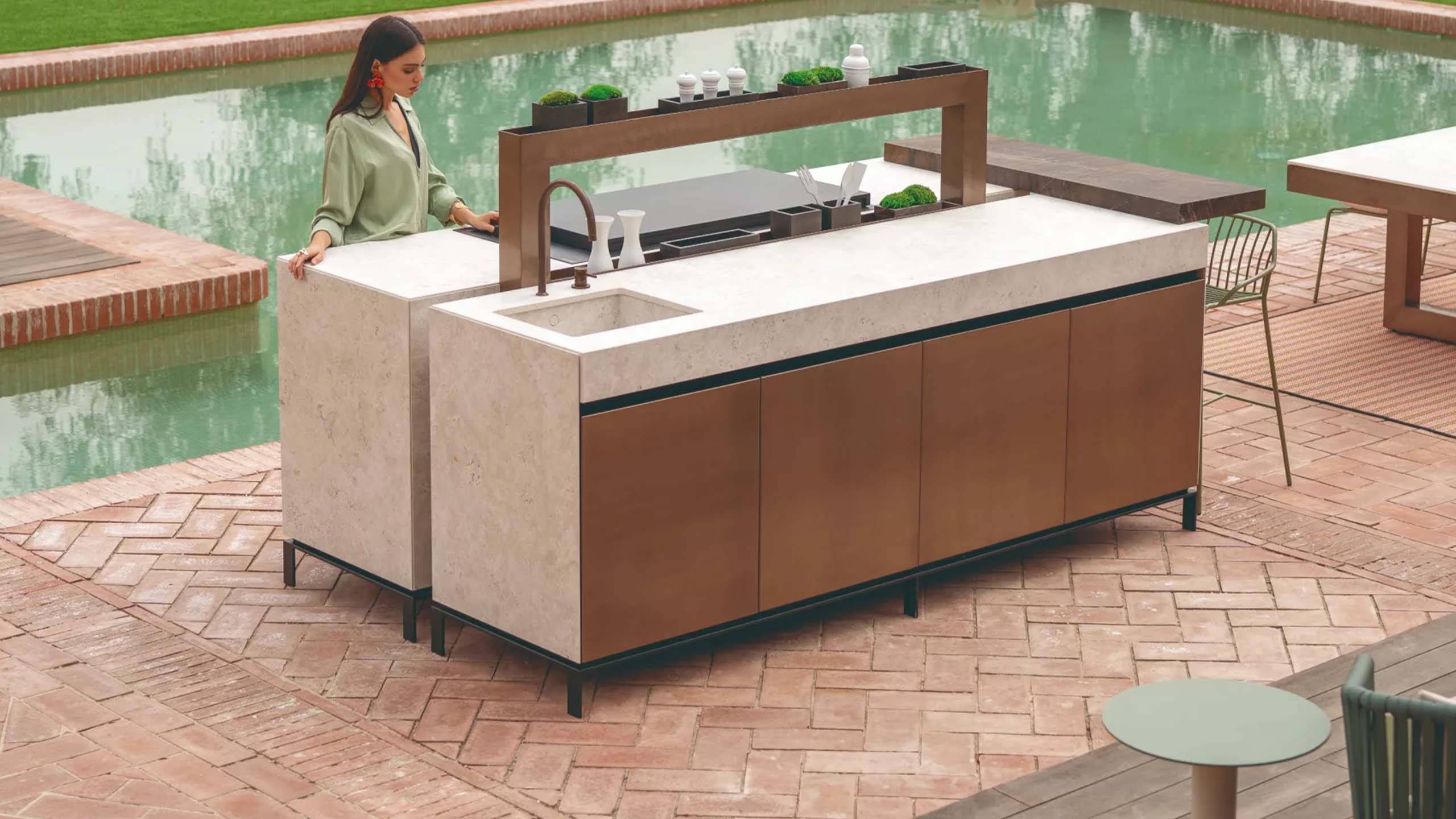 Image of the Krieder KX natural-look luxury outdoor kitchen, showcasing modules with wood-effect cladding, integrated planter boxes, and a modern cooking area.
